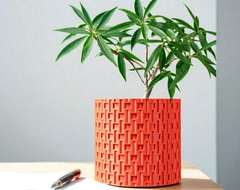 Geometrische moderne plantenbak – levendig oranjerood interieuraccent