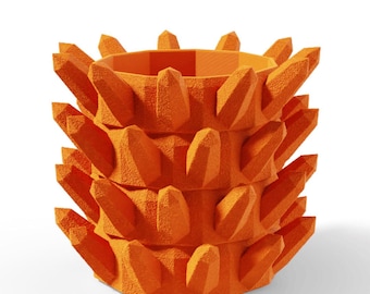 May include: A bright orange cylindrical planter featuring a textured surface with numerous protruding, crystal-like spikes arranged in three horizontal rows around the exterior. The top opening is circular with a smooth inner rim.