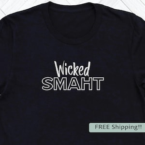 May include: Black crew neck t-shirt with the words "Wicked SMAHT" in white, a play on words. The shirt is made of a soft material and is suitable for casual wear.