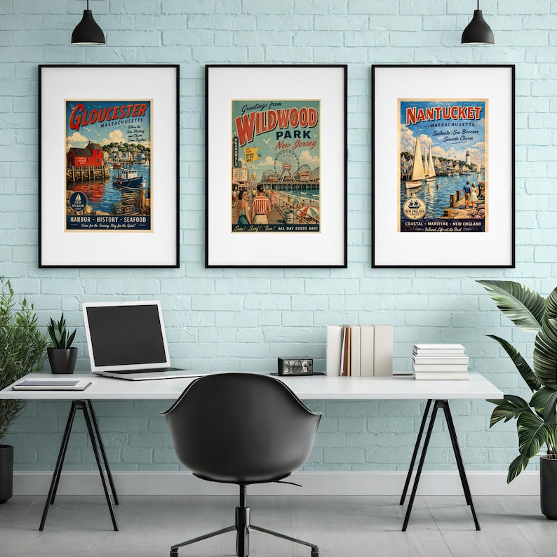 May include: Three framed vintage travel posters. The posters feature colorful illustrations of Gloucester, Massachusetts; Wildwood Park, New Jersey; and Nantucket, Massachusetts. The posters are displayed above a white desk with a laptop and office supplies.