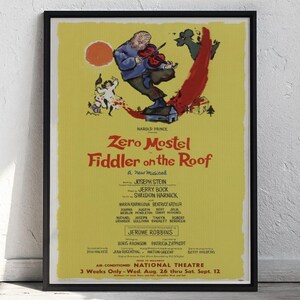 May include: A framed poster for the musical "Fiddler on the Roof" featuring Zero Mostel. The poster has a yellow background with a cartoon illustration of a man playing a violin. The poster includes the names of the cast and crew.