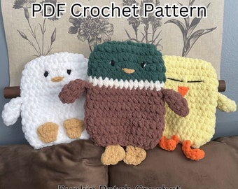 May include: PDF crochet pattern for three amigurumi animal toys: a white duck, a brown and green duck, and a yellow chick. The toys are made with a textured yarn and have embroidered facial features. The pattern is by Punkin Patch Crochet.