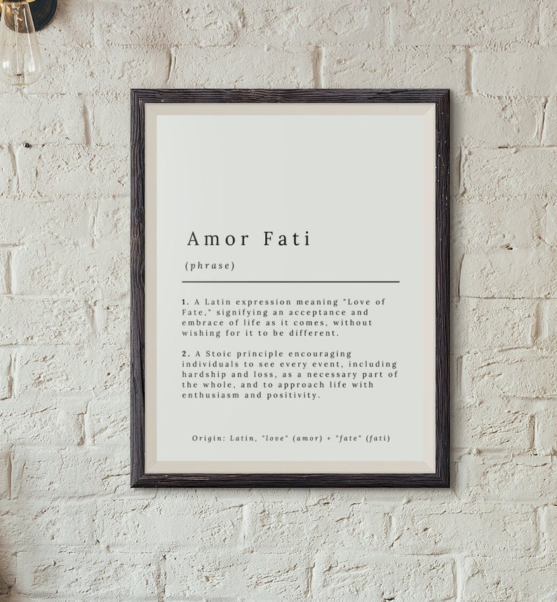 May include: A black and white printable wall art print with the Latin phrase "Amor Fati" defined as "Love of Fate". The definition explains the meaning of the phrase and its origin in Latin.