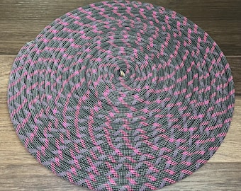 May include: A coiled rope with a black and pink diamond pattern.