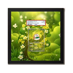May include: A framed collectible trading card featuring a Rowlet illustration set against a vibrant green forest background with yellow flowers. Above the card, a PSA grading label displays the text 2023 POKEMON MEW EN BLASTOISE ex GEM MT 10.