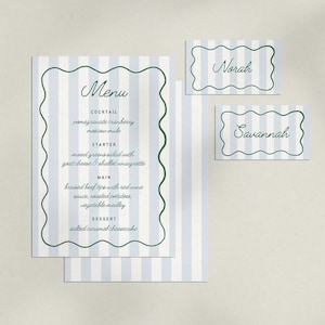 May include: A set of stationery with a light blue and white striped design. The set includes a menu, and two name cards. The menu features a scalloped border and a list of menu items. The name cards have the names "Norah" and "Savannah".