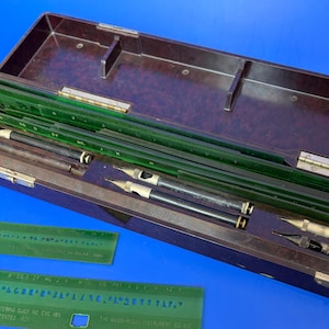 May include: A handmade, wooden cutting board with a natural finish. The board features a live edge on one side and a smooth, rectangular shape. It is approximately 18 inches long and 12 inches wide.