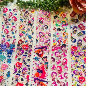May include: A collection of clear sticker sheets featuring colorful cartoon characters in various poses. The stickers have a variety of designs, including musical notes, stars, and floral patterns. The characters have different hairstyles and outfits.
