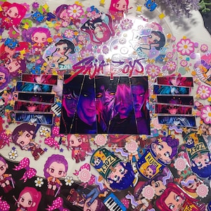 May include: A collection of colorful stickers featuring anime-style characters, flowers, and the text "Zoe Boys." The stickers have a variety of designs, including portraits and cartoon figures, with a vibrant color palette of pink, purple, and blue.