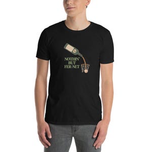 May include: Black t-shirt with a graphic of a bottle pouring liquid into a basketball net, with the text "NOTHIN' BUT FER-NET" in green and white. The shirt is made of a soft material.