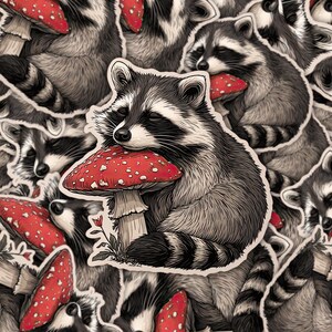 May include: A collection of stickers featuring a raccoon hugging a red mushroom with white spots. The raccoon is black and gray with a striped tail. The mushrooms have a white stem and are surrounded by other raccoon and mushroom stickers.