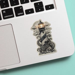 May include: A black and white sticker of a lighthouse with a lit lamp at the top. The lighthouse is surrounded by clouds and has tentacles at the base. The sticker is on a laptop.