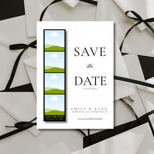 May include: A white 'Save the Date' card with black text and a landscape photo strip. The card reads 'SAVE the DATE' with the names 'EMILY & RYAN' and the date 'MARCH 28, 2026'. Black ribbon and white envelopes are in the background.