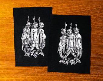 Captured sirens after Albrecht Dürer. Hanging mermaids or nymphs. Medieval woodcut. Screen printed patch.