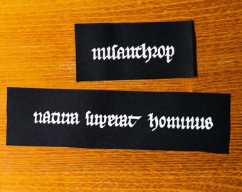 Misanthrop. Nature is above humankind. Natura superat hominus. Medieval manuscript. Screen printed black cotton patch.