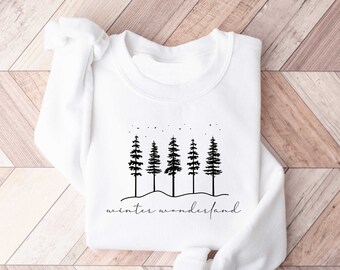 May include: White sweatshirt with a black graphic of five pine trees and the text "winter wonderland".