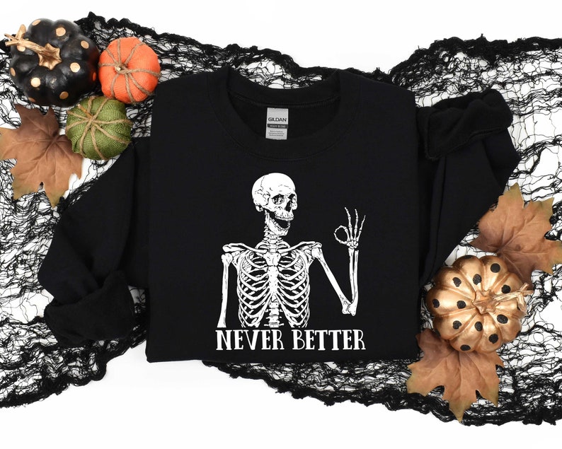May include: Black sweatshirt with a white skeleton graphic giving a thumbs up and the text "Never Better".