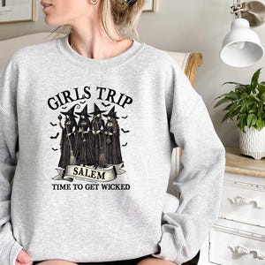 May include: Gray sweatshirt with a black and white graphic of four witches with the text "Girls Trip Salem, Autumn's Magic, Time to Get Wicked".