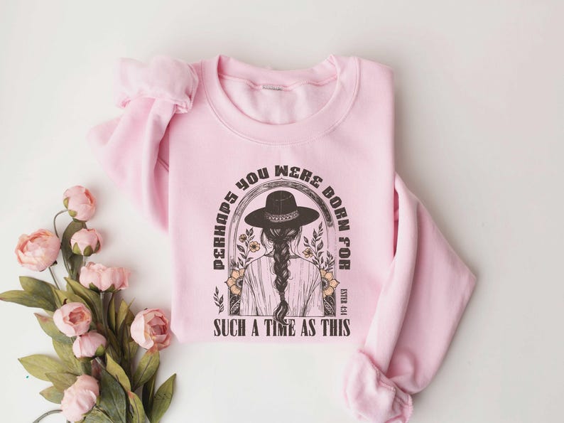 May include: Pink sweatshirt with a graphic print of a woman wearing a hat and the text "Perhaps you were born for such a time as this" with the Bible verse Esther 4:14.