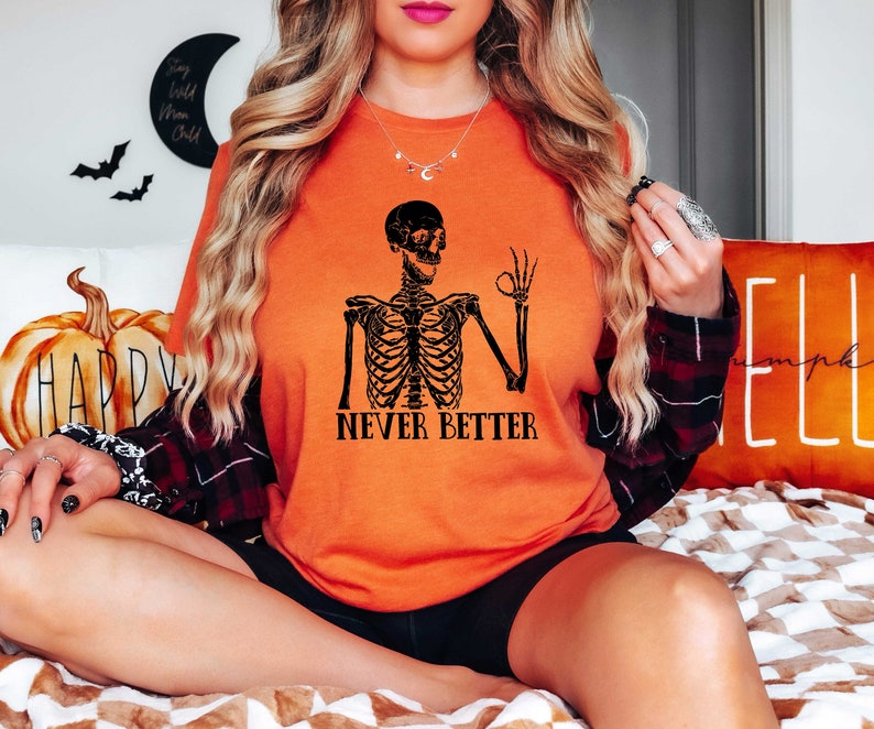 May include: Orange t-shirt with a black skeleton graphic and the text "Never Better".