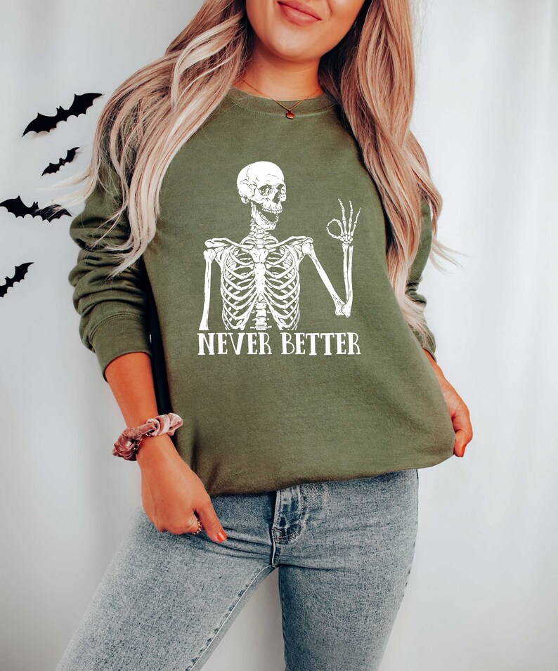 May include: A green sweatshirt with a white skeleton graphic and the text "NEVER BETTER".
