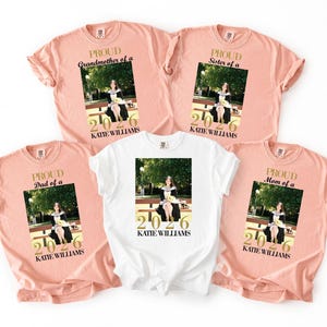 May include: A collection of peach and white t-shirts featuring a graduation photo and the text "PROUD Grandmother of a", "PROUD Dad of a", "PROUD Sister of a", and "PROUD Mom of a". Each shirt includes the graduate's name and the year 2026.
