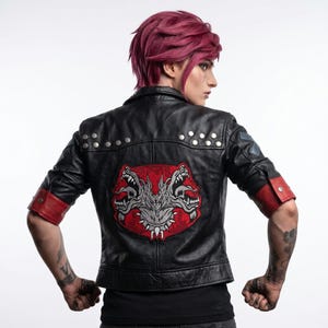 May include: Black leather jacket with a red and grey graphic of two snarling wolf-like creatures on the back. The jacket has red cuffs and silver studs along the shoulders.