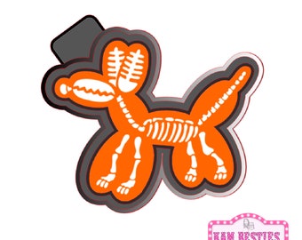 May include: Orange balloon animal shaped like a dog with a white skeleton inside. The balloon animal is outlined in black.