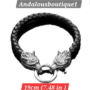 May include: Black braided leather bracelet with silver-colored wolf head accents. The bracelet is 7.48 inches (19 cm) in length. The text "Andalousboutique1" is at the top.