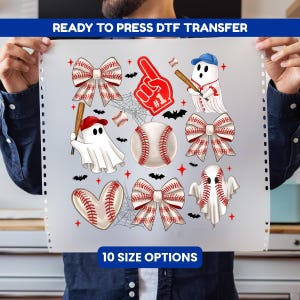 May include: A ready to press DTF transfer sheet featuring baseball-themed graphics including ghosts in baseball caps, baseballs, heart-shaped baseballs, bows with baseball stitching, a red foam finger, spiderwebs, and bats. Text reads 10 SIZE OPTIONS.