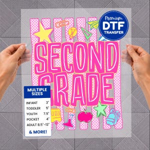 May include: A clear DTF transfer sheet featuring the pink text SECOND GRADE over a pink polka-dot striped background. Graphics include a yellow star, lightbulb, paper airplane, school bus, beaker, apple, and backpack. Includes a size chart.