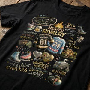 May include: Black t-shirt with a graphic design featuring hockey jerseys, ice skates, and text. The text includes phrases like "Heated Rivalry," "We didn't even kiss," and "Whatever happens, I'm with you." The design incorporates hearts and other decorative elements.
