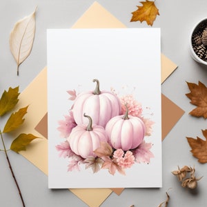 May include: A watercolor painting of three pink pumpkins with brown stems and leaves. The pumpkins are surrounded by pink flowers and brown leaves.