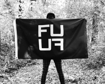 May include: A person holding a black flag with the word "FU" written in white letters.