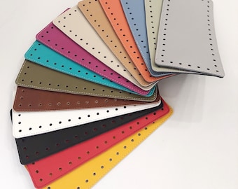 May include: A fan of 12 different colored leather pieces with holes punched in them. The leather pieces are arranged in a semi-circle with the lightest color at the top and the darkest color at the bottom.