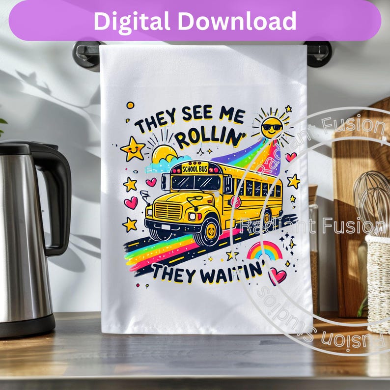 May include: A white tea towel with a yellow school bus illustration and the text "They see me rollin' They waitin'" in colorful letters. The bus is driving on a rainbow road with stars and hearts.