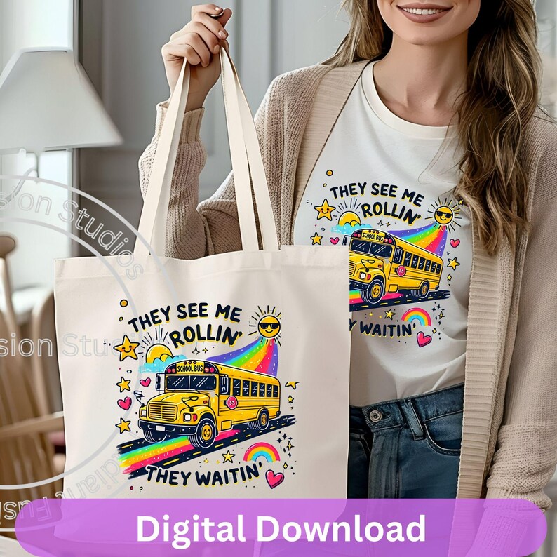 May include: A white tote bag with a yellow school bus graphic and the text "They See Me Rollin' They Waitin'" in black and white. The bus has a rainbow behind it and stars and hearts around it.