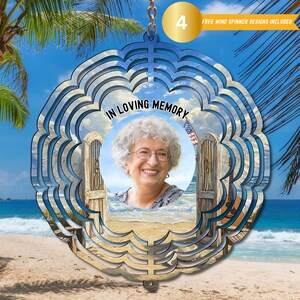May include: A metal wind spinner with a beach scene and a photo of a woman. The spinner has the words "In Loving Memory" on it.