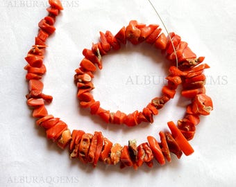 May include: A strand of coral beads, featuring a mix of orange and red hues. The beads are irregular in shape and size, creating a natural and organic look. The coral beads are strung on a thin wire, ready to be used for jewelry making.