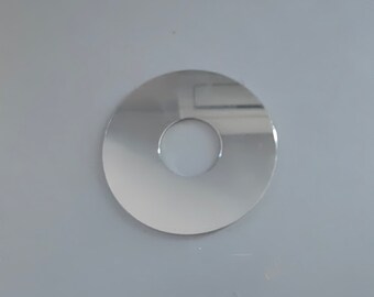 May include: A silver-colored metal ring with a hole in the center. The ring is smooth and reflective.