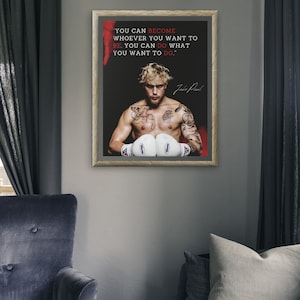May include: Framed print with a motivational quote and a portrait of a man wearing boxing gloves. The text reads: "YOU CAN BECOME WHOEVER YOU WANT TO BE. YOU CAN DO WHAT YOU WANT TO DO." The print is in a wooden frame.