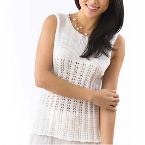 May include: White sleeveless crochet top with a delicate openwork pattern. The top has a round neckline and a relaxed fit.