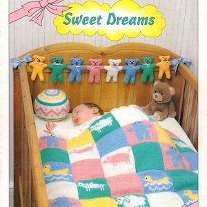 May include: A knitted baby blanket with a patchwork design featuring various animals, including sheep, pigs, and bears. The blanket is in shades of pink, blue, green, and yellow. A baby is sleeping in a crib with a knitted teddy bear mobile hanging above. The text "Sweet Dreams" is displayed in a yellow cloud shape. The text "Little extras for your baby" is displayed at the bottom of the image.