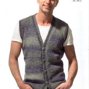 May include: A grey and purple striped knitted waistcoat with a V-neck and button fastening. The waistcoat is being worn by a person with a white undershirt and black jeans. Aran 97 - 122 cm 38 - 48 in