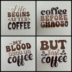 May include: Four coffee-themed stickers with brown and white lettering on a white background. The stickers say "Life Begins After Coffee", "Coffee Before Chaos", "My Blood Type Is Coffee", and "But First Coffee".