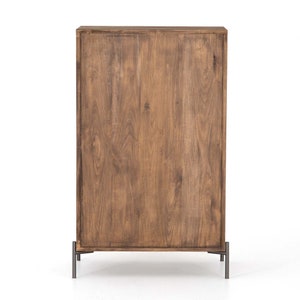 May include: A wooden cabinet with a brown finish and metal legs. The cabinet has a simple design with a rectangular shape and a flat top.