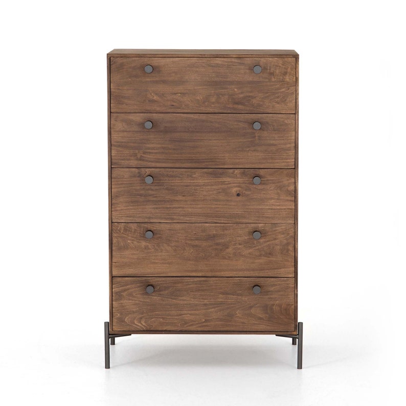 May include: A five-drawer chest of drawers with a dark wood finish and black metal legs. The drawers have round metal knobs.