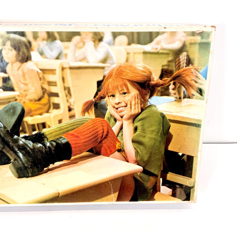 May include: A white ceramic mug with a black handle and the text "But First, Coffee" in a black, handwritten-style font. The mug is on a white surface.