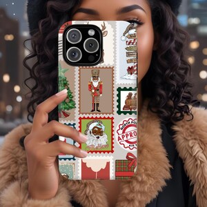 May include: A phone case featuring a collage of Christmas-themed postage stamp designs. The stamps include images of a Christmas tree, a nutcracker, Santa Claus, a train, and a North Pole approval stamp. The case has a beige background with red, green, and brown accents.