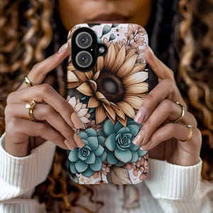 May include: A phone case with a floral design featuring sunflowers, succulents, and other flowers in shades of brown, green, and white.